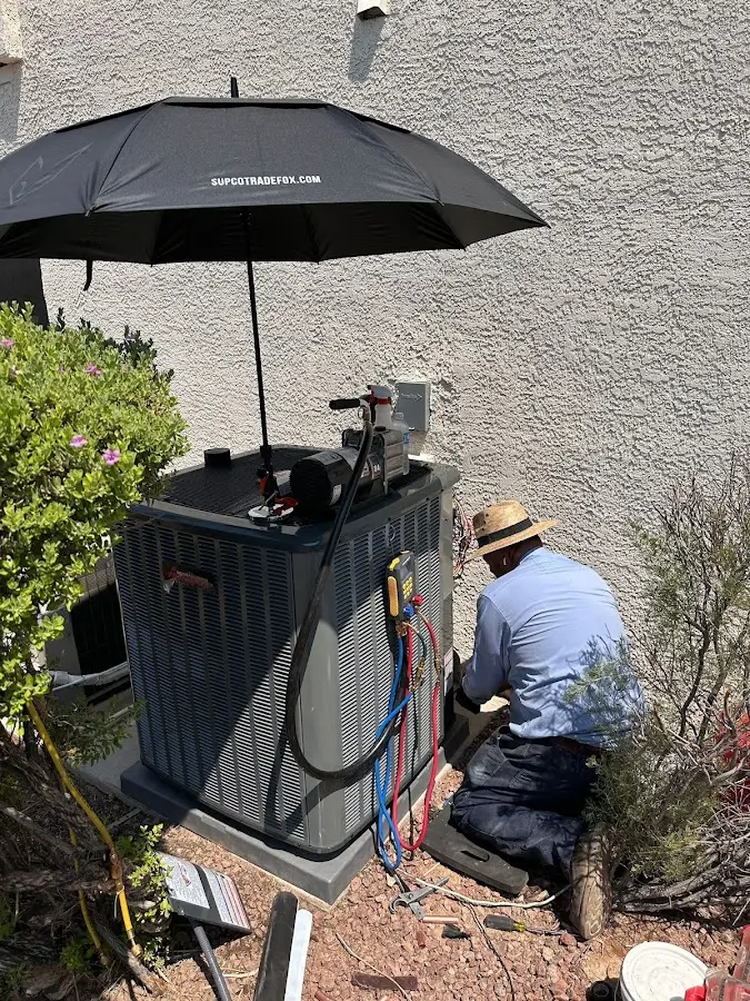 HVAC technician performing outdoor AC maintenance in Dulles Town Center