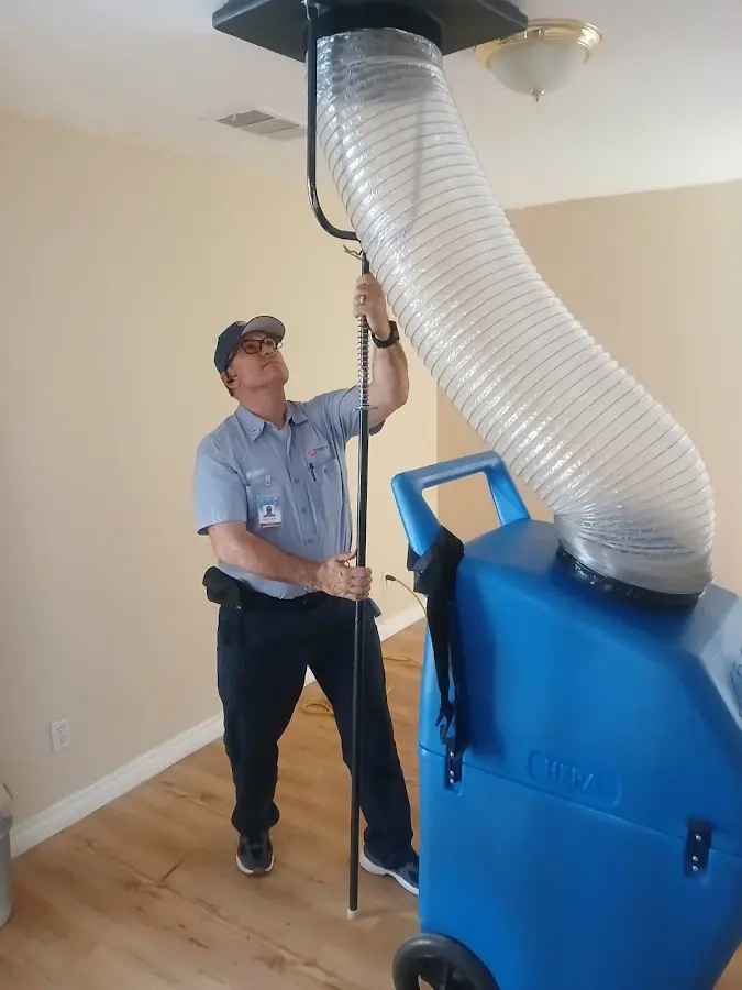 Furnace Tune-Up technician using HEPA equipment in Dulles Town Center